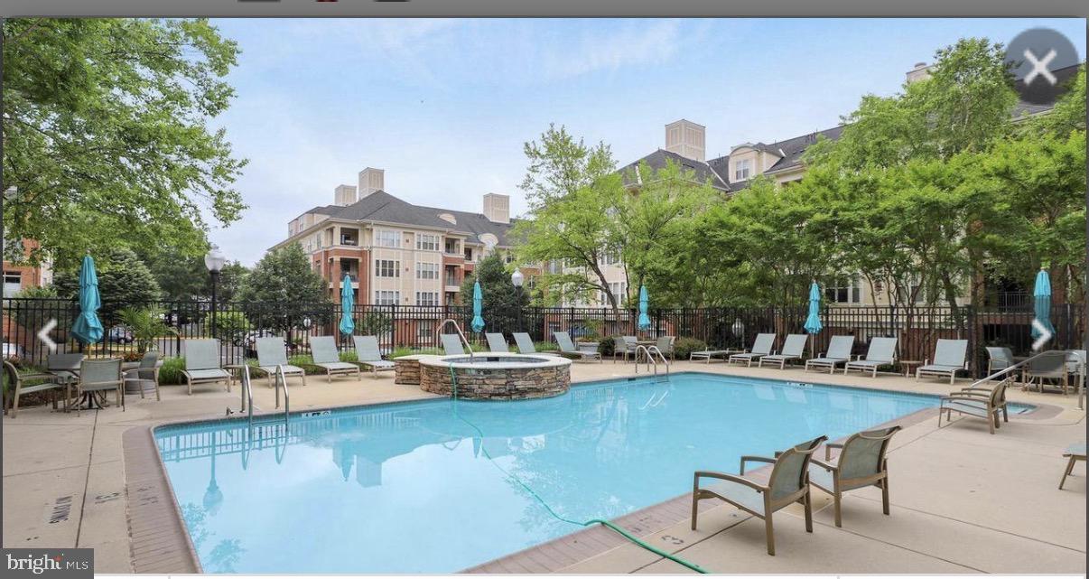 1855 Stratford Park Place, Unit 214 Reston, VA 20190 - Photo 19 of 29 a view of a swimming pool with outdoor seating