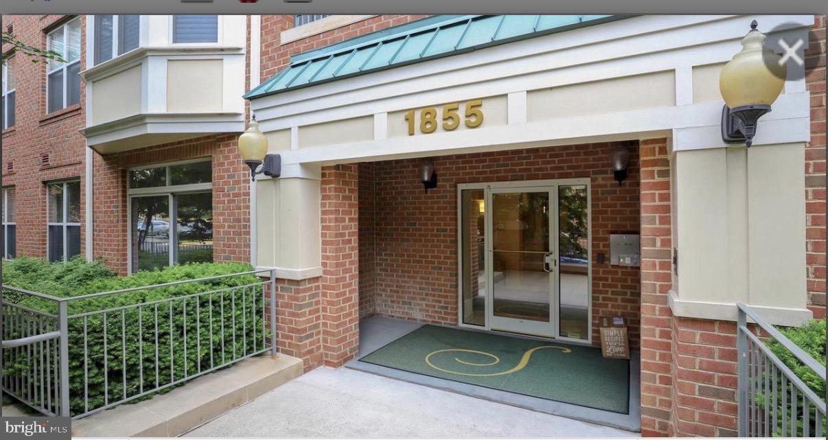 1855 Stratford Park Place, Unit 214 Reston, VA 20190 - Photo 2 of 29 front view of a brick building