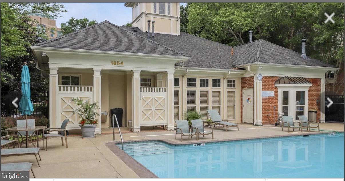 1855 Stratford Park Place, Unit 214 Reston, VA 20190 - Photo 21 of 29 a front view of a house with swimming pool and sitting area