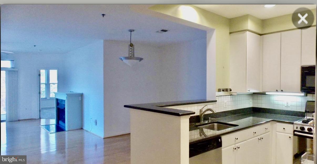 1855 Stratford Park Place, Unit 214 Reston, VA 20190 - Photo 27 of 29 a kitchen that has a sink and a stove in it