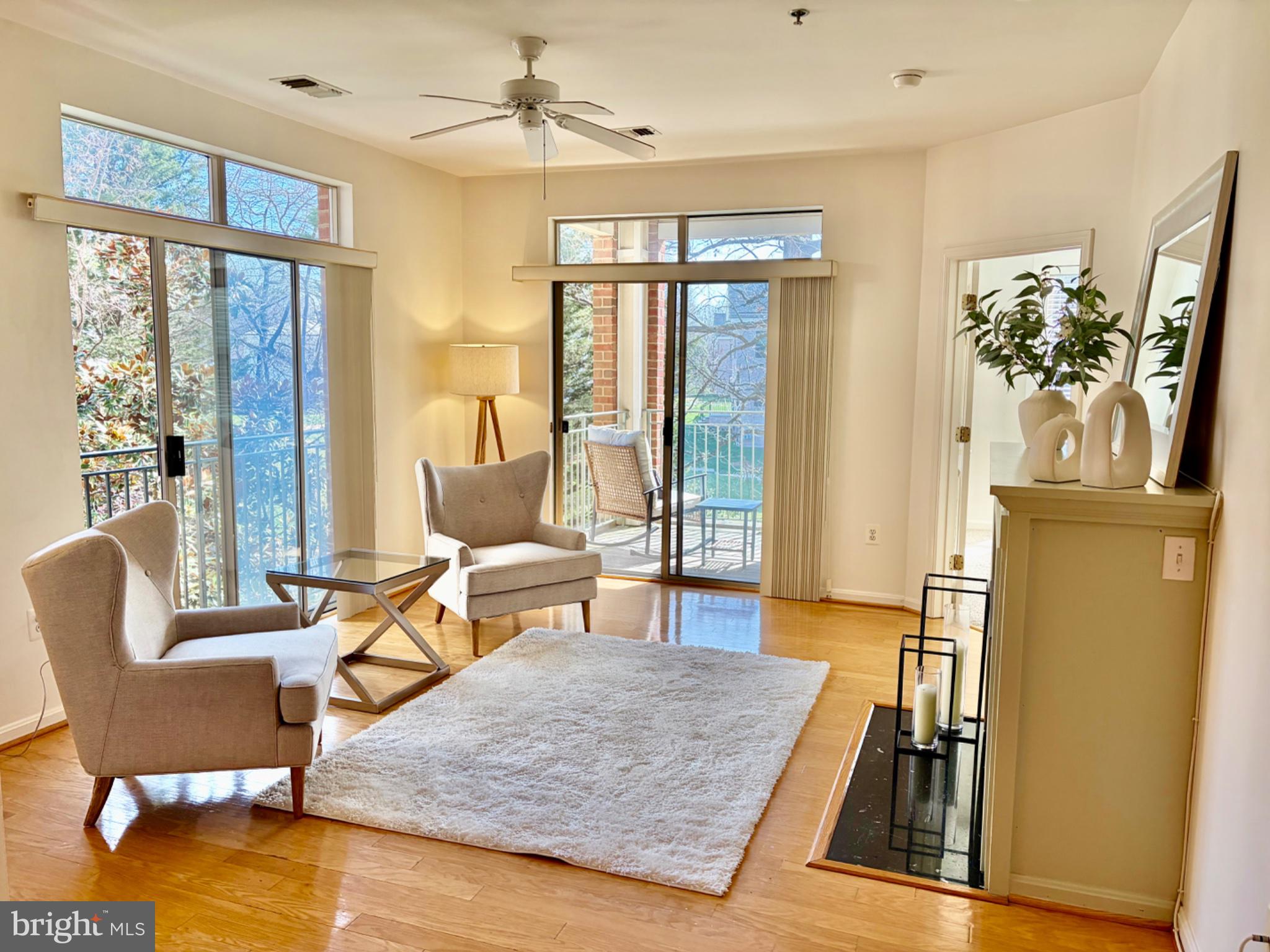1855 Stratford Park Place, Unit 214 Reston, VA 20190 - Photo 6 of 29 a living room with furniture and a table