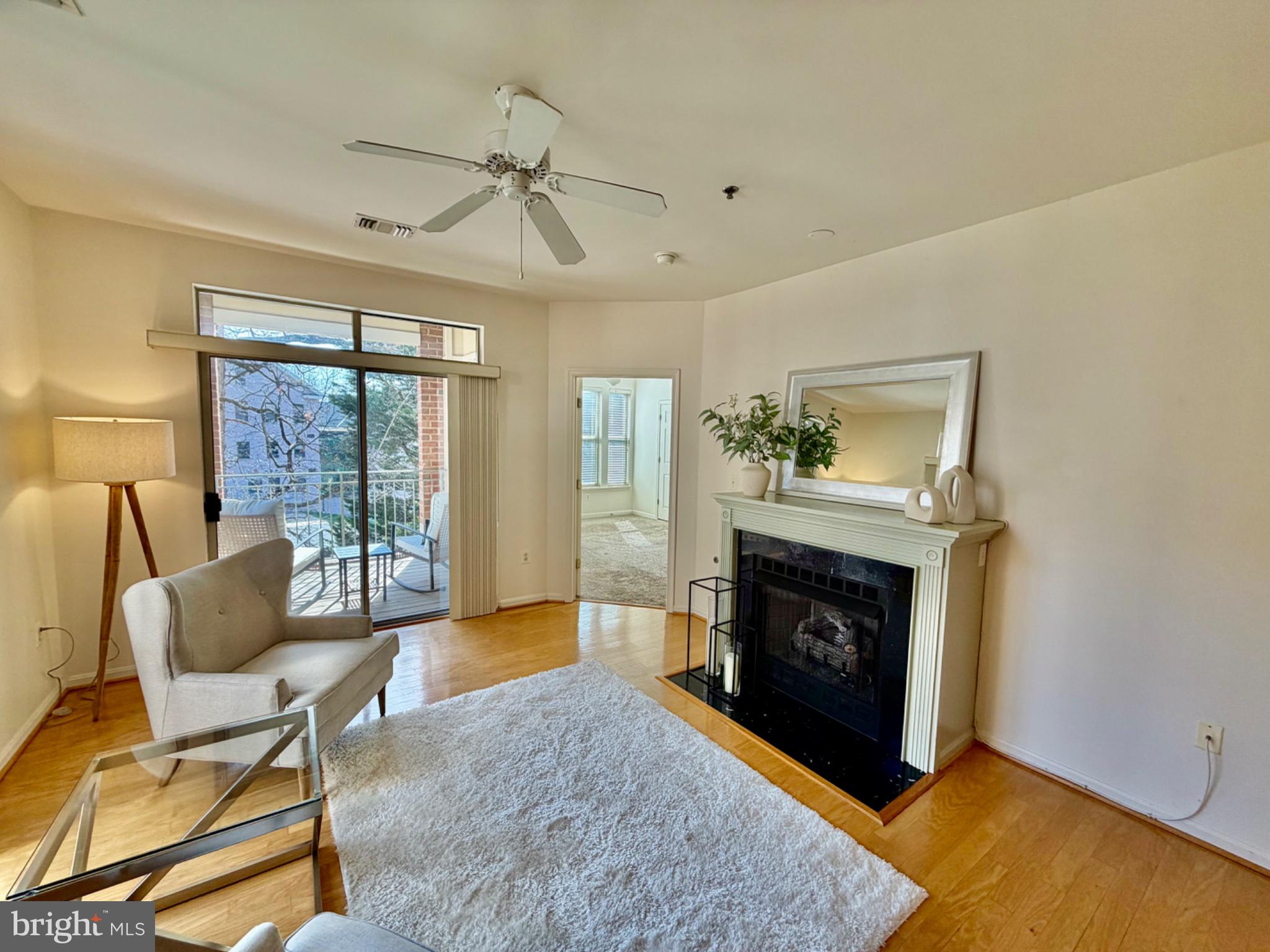 1855 Stratford Park Place, Unit 214 Reston, VA 20190 - Photo 7 of 29 a living room with furniture and a fireplace
