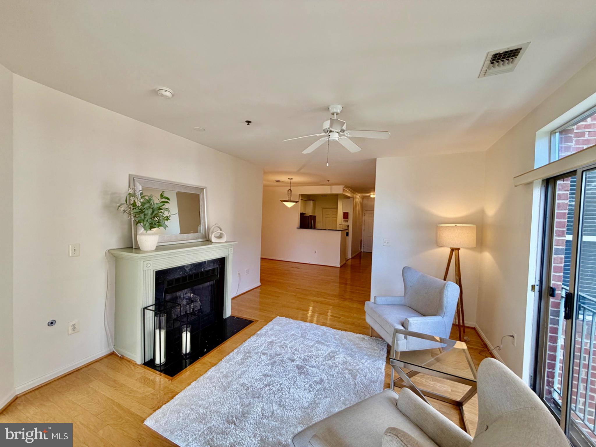 1855 Stratford Park Place, Unit 214 Reston, VA 20190 - Photo 8 of 29 a living room with furniture and a fireplace