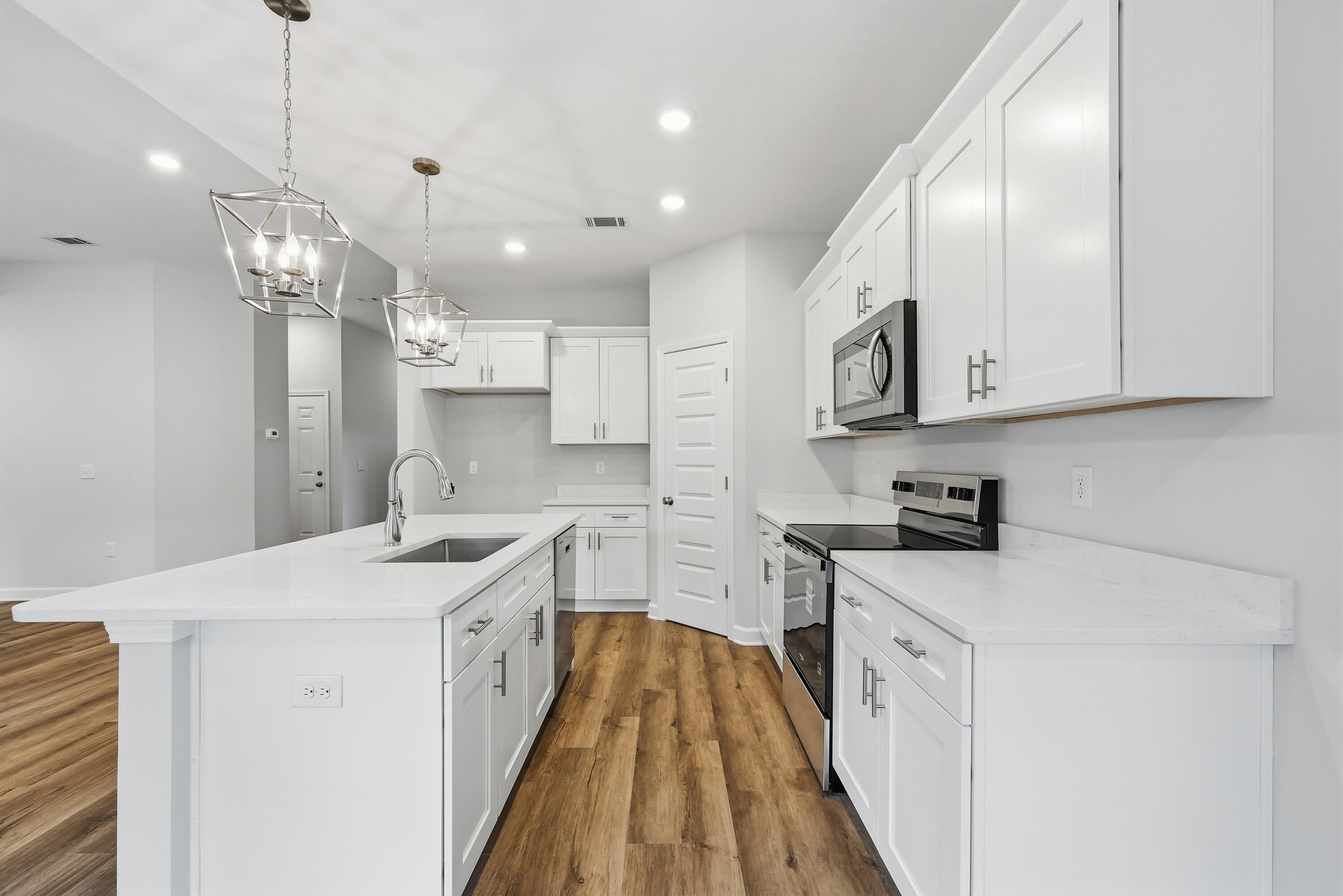 6108 Mildred's Way Crestview, FL 32539 - Photo 12 of 27 a kitchen with stainless steel appliances granite countertop a sink a stove and a refrigerator