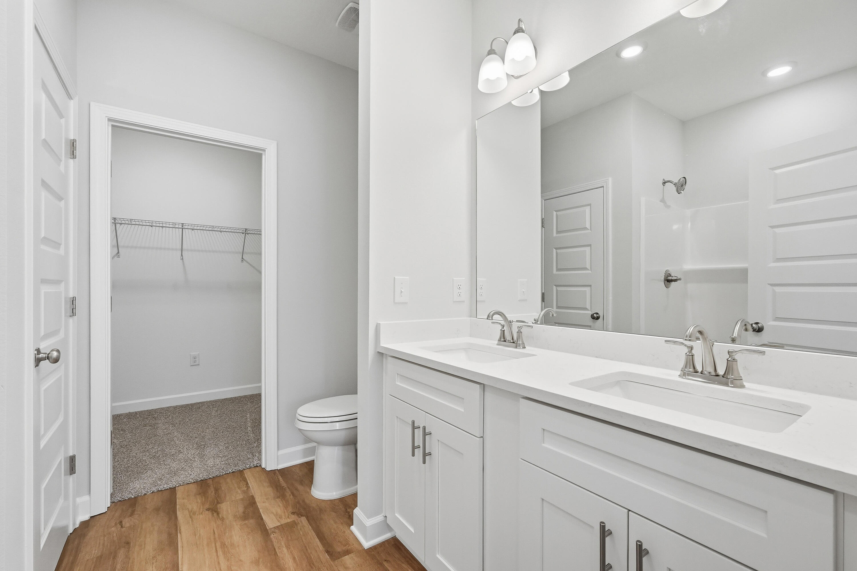 6108 Mildred's Way Crestview, FL 32539 - Photo 16 of 27 a bathroom with a sink a toilet and a large mirror