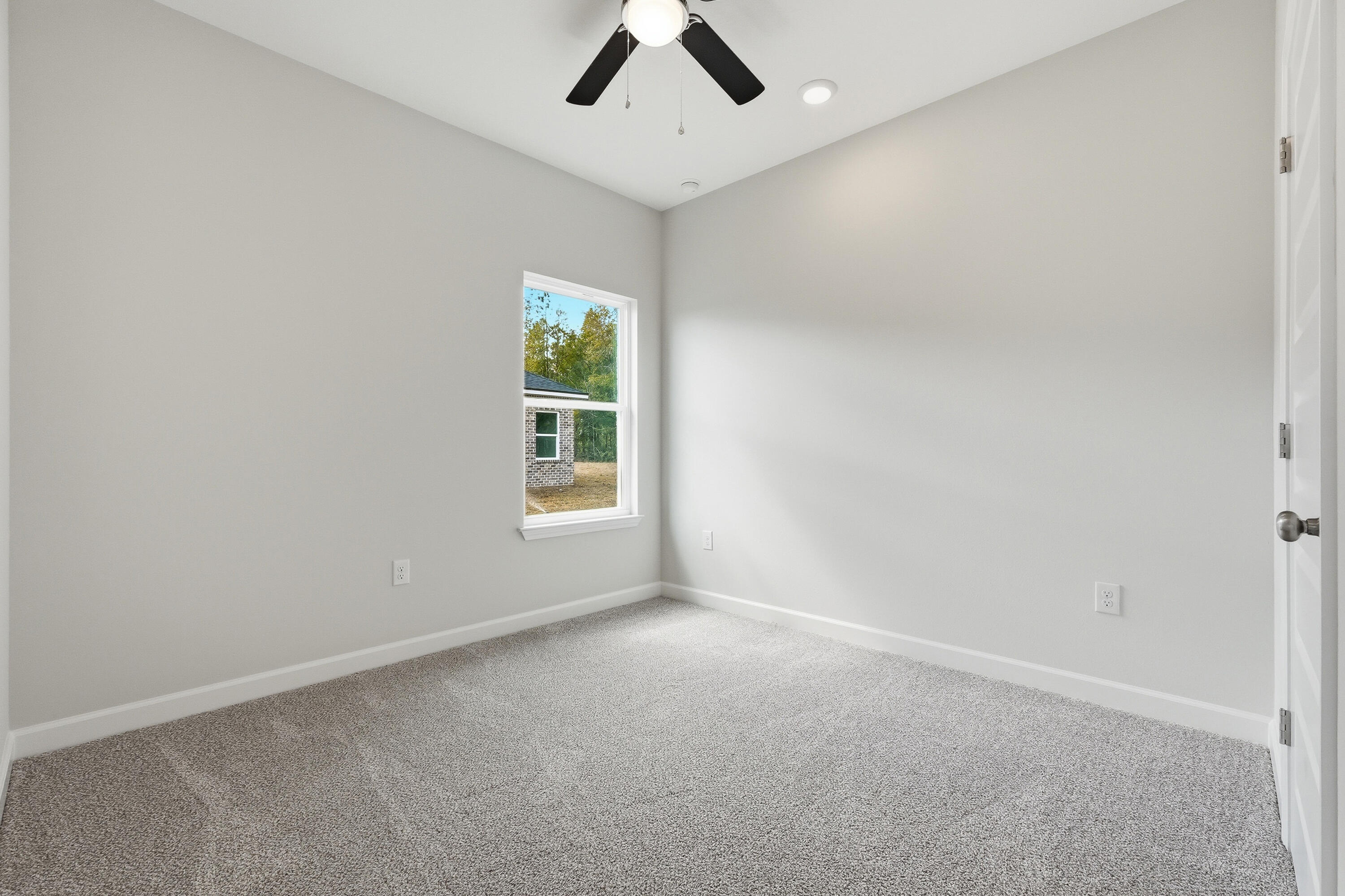 6108 Mildred's Way Crestview, FL 32539 - Photo 20 of 27 an empty room with a window and a ceiling fan