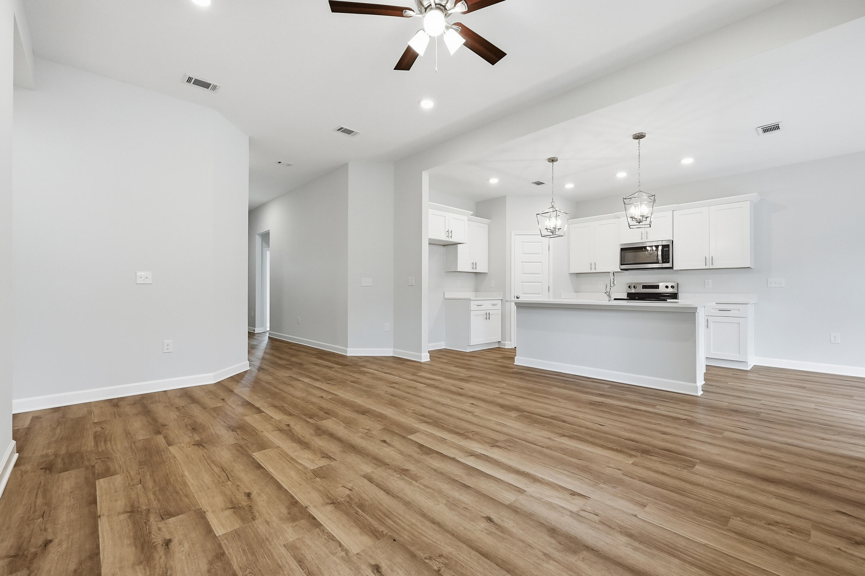 6108 Mildred's Way Crestview, FL 32539 - Photo 6 of 27 a view of kitchen with granite countertop cabinets and refrigerator