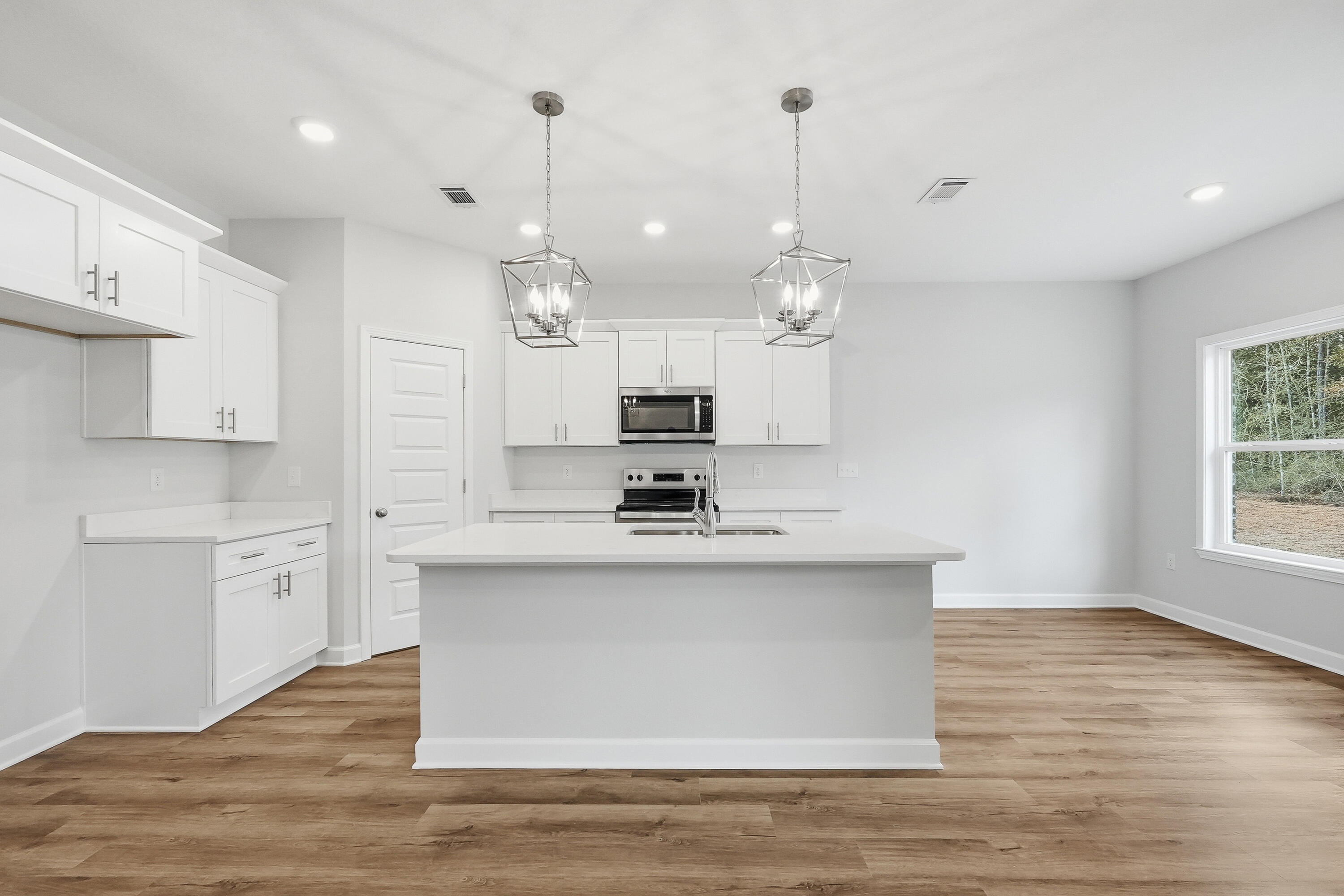 6108 Mildred's Way Crestview, FL 32539 - Photo 9 of 27 a view of a kitchen with kitchen island a sink stainless steel appliances and cabinets