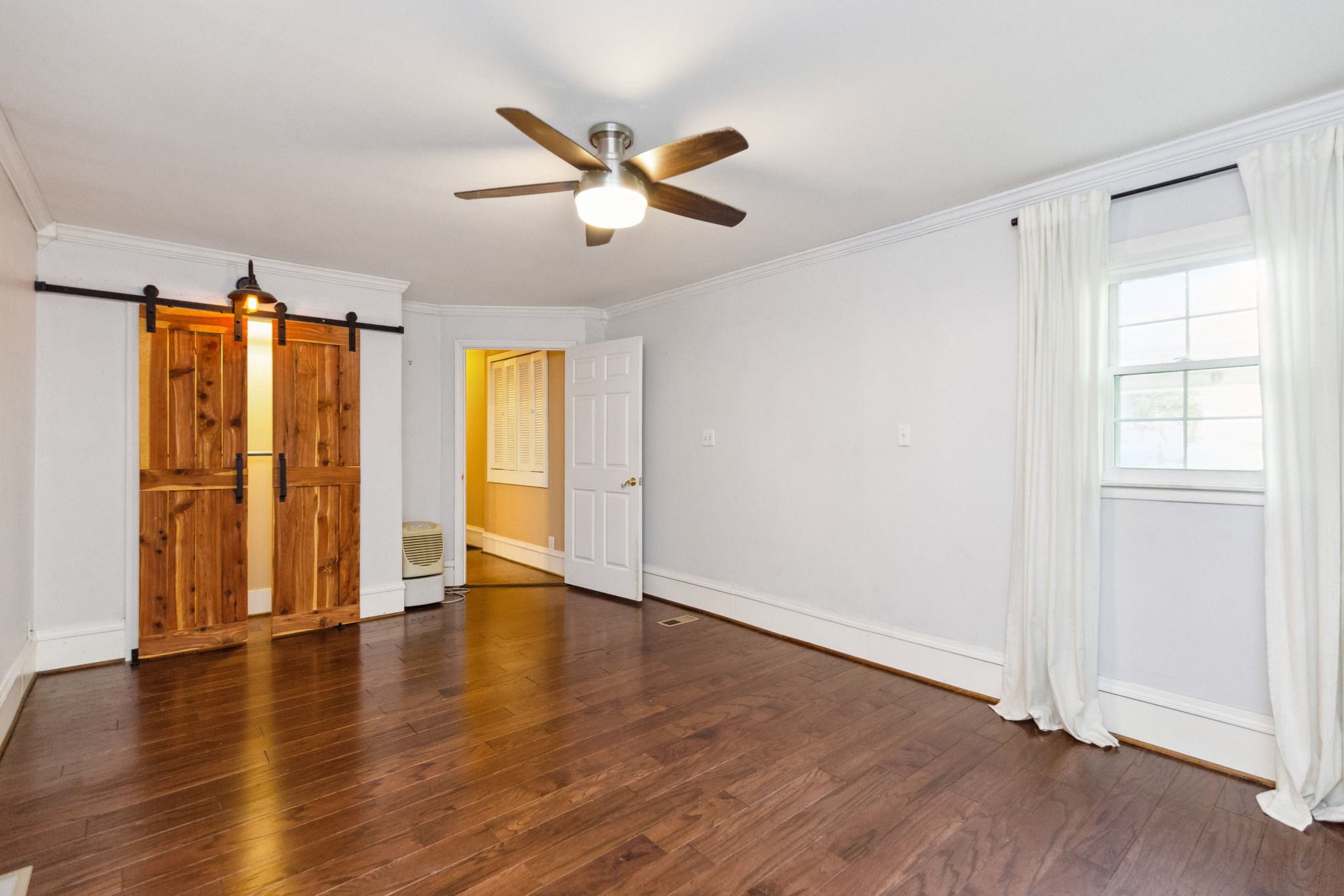 831 3rd Street Tracy City, TN 37387 - Photo 12 of 25 an empty room with wooden floor closet and windows