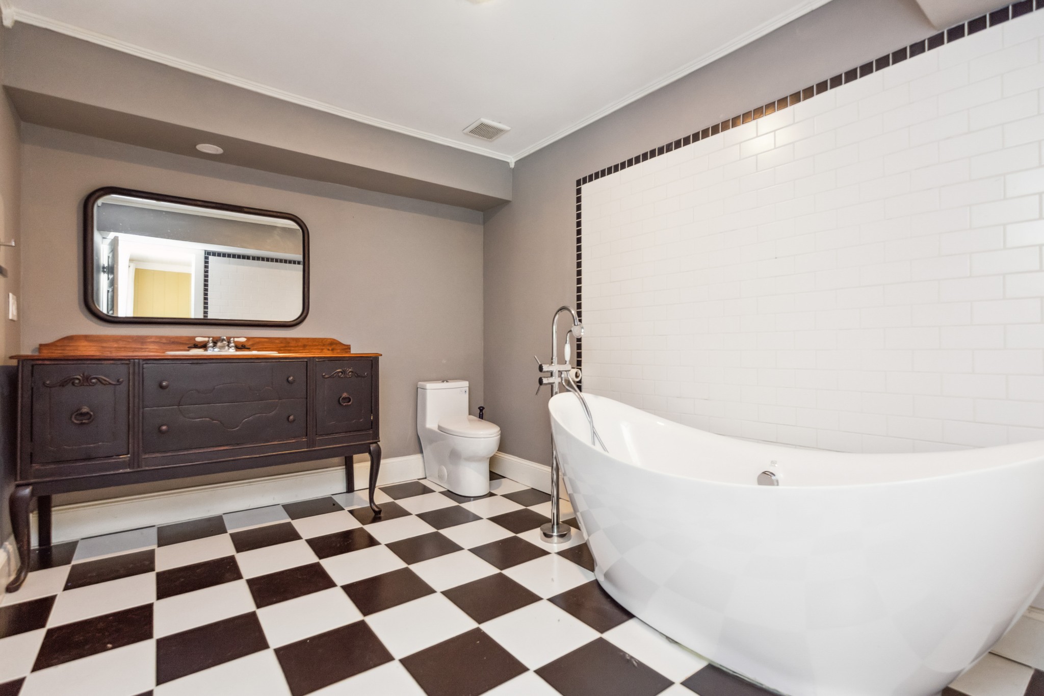 831 3rd Street Tracy City, TN 37387 - Photo 19 of 25 a bathroom with a black and white checkered floor