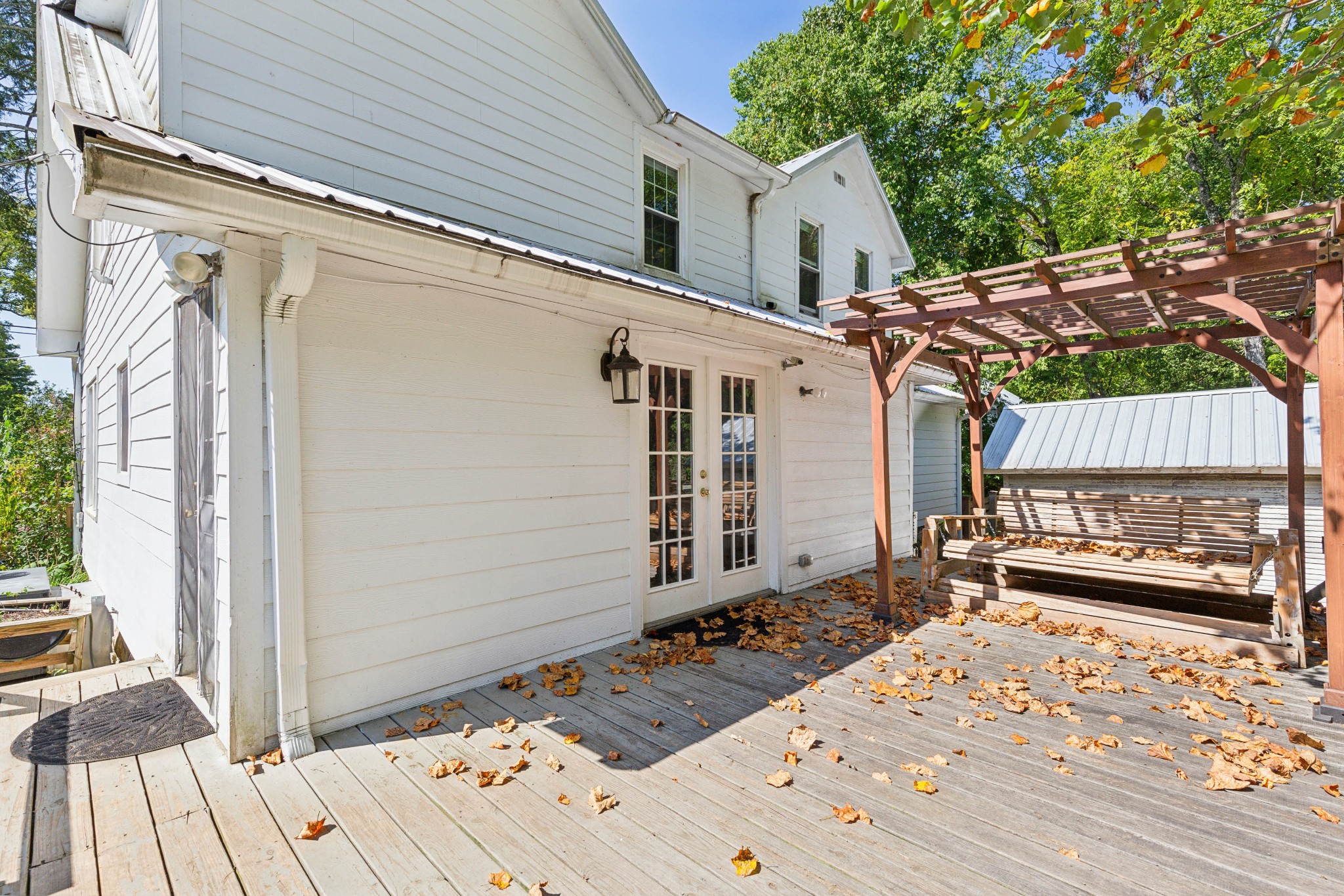 831 3rd Street Tracy City, TN 37387 - Photo 20 of 25 a wooden bench sitting in front of a house