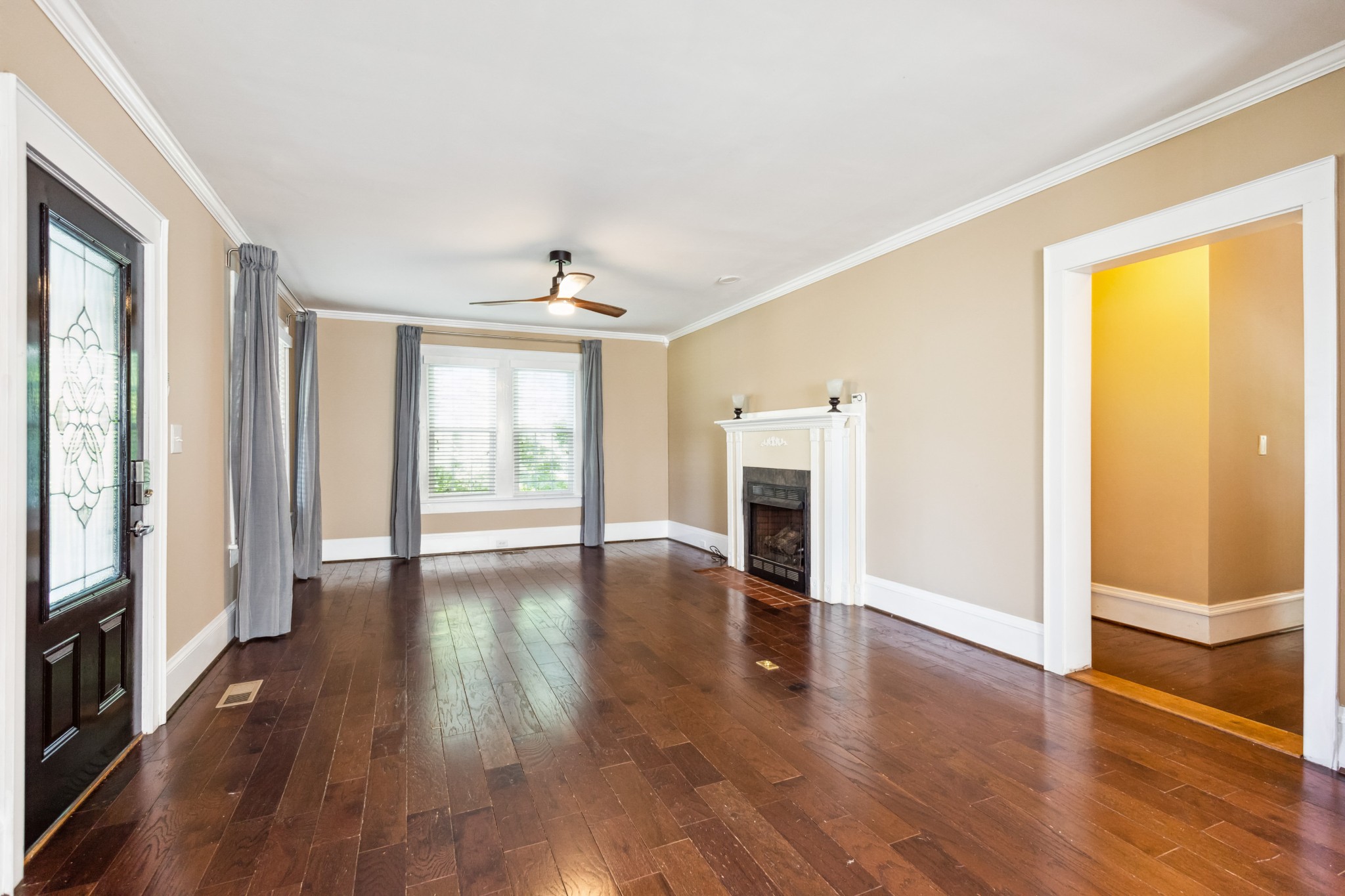 831 3rd Street Tracy City, TN 37387 - Photo 2 of 25 a view of an empty room with wooden floor and a window