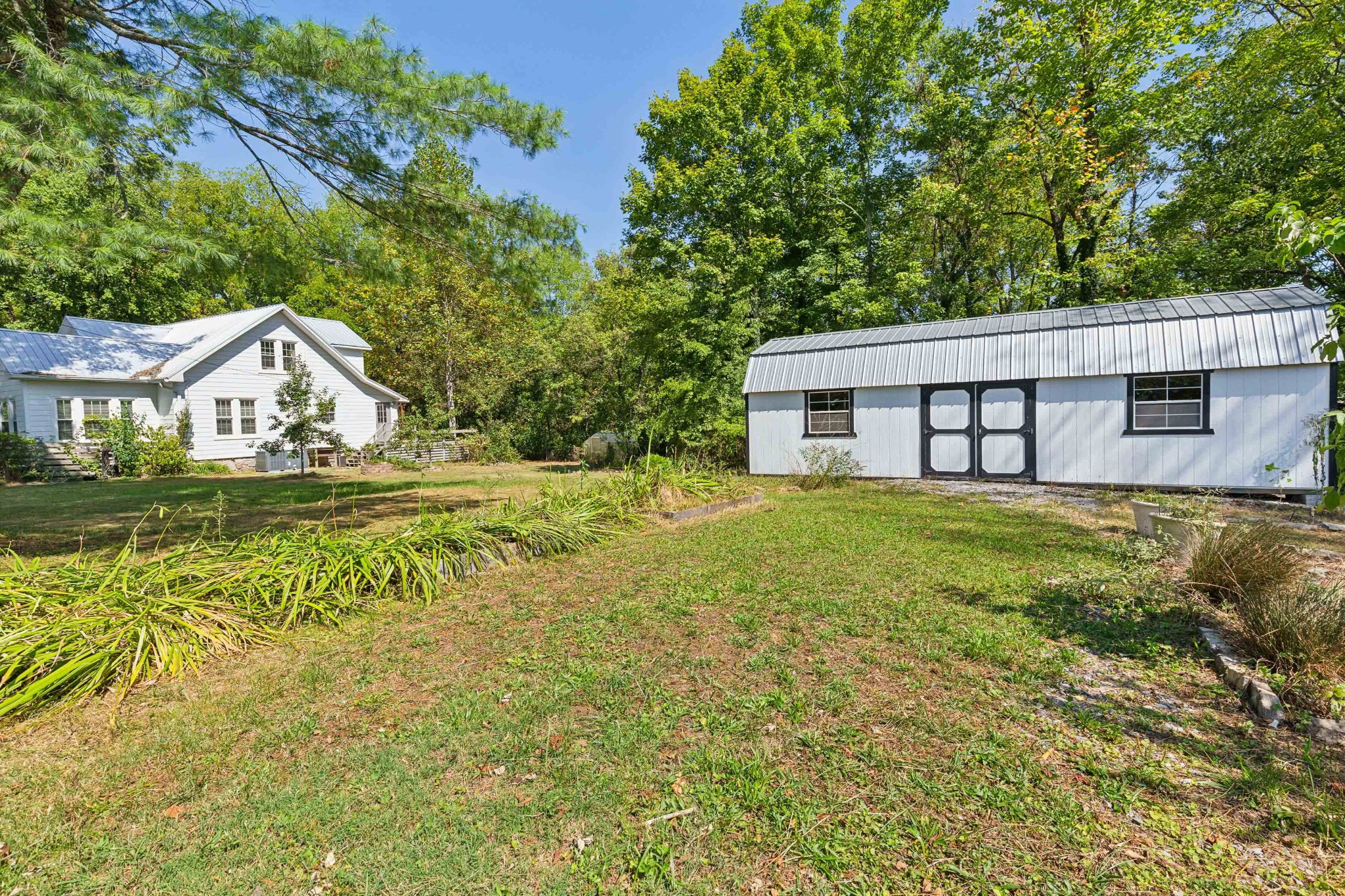 831 3rd Street Tracy City, TN 37387 - Photo 23 of 25 a house with swimming pool in front of it