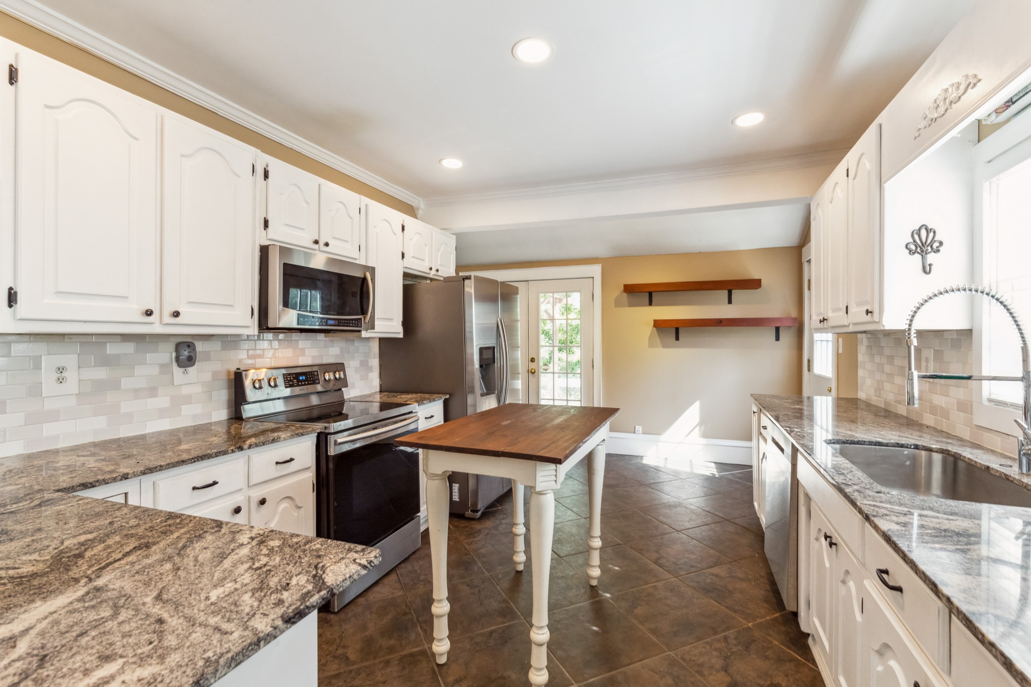 831 3rd Street Tracy City, TN 37387 - Photo 7 of 25 a kitchen with stainless steel appliances granite countertop a sink stove and refrigerator