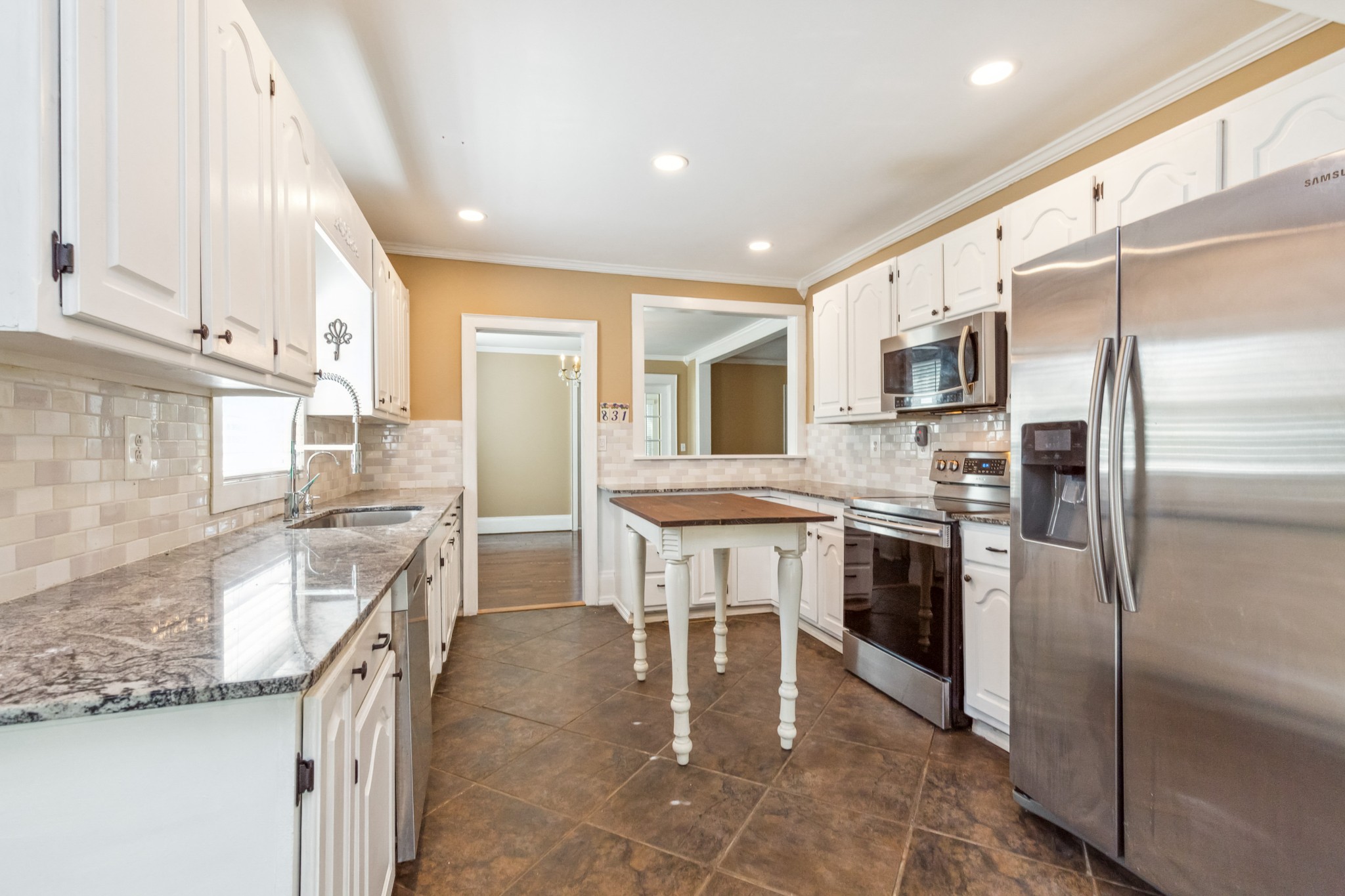 831 3rd Street Tracy City, TN 37387 - Photo 8 of 25 a kitchen with granite countertop a sink appliances cabinets and counter space