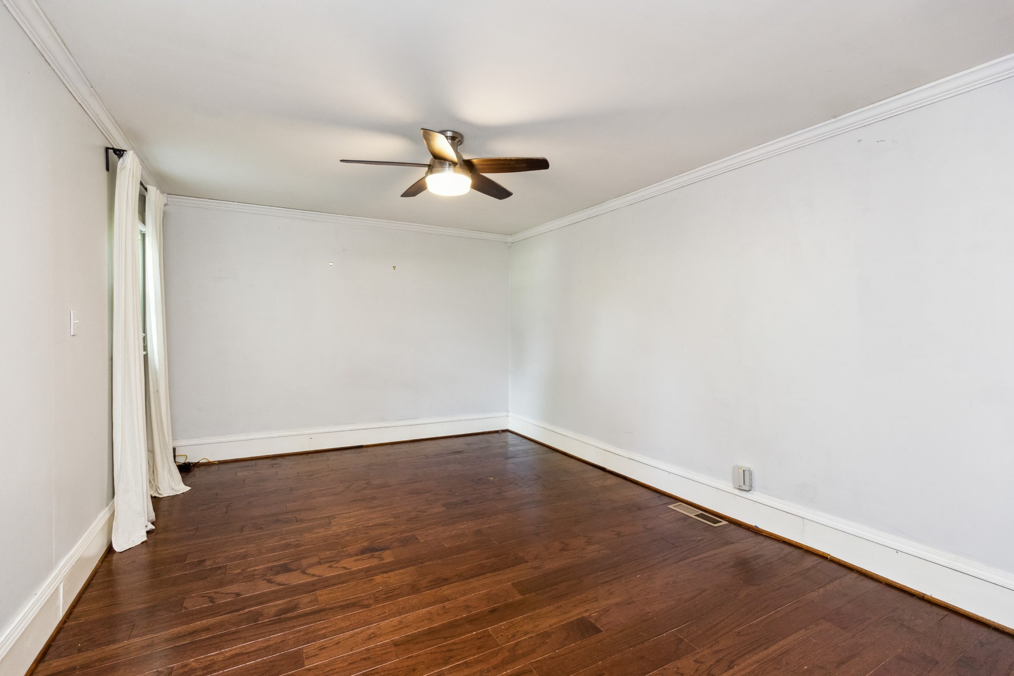 831 3rd Street Tracy City, TN 37387 - Photo 10 of 25 an empty room with wooden floor fan and windows