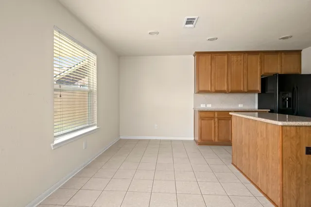 a kitchen with stainless steel appliances granite countertop a sink stove refrigerator and cabinets