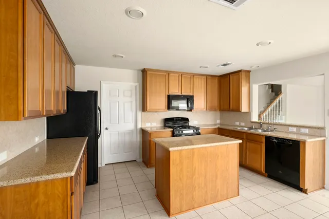 a kitchen with a stove a sink and a refrigerator