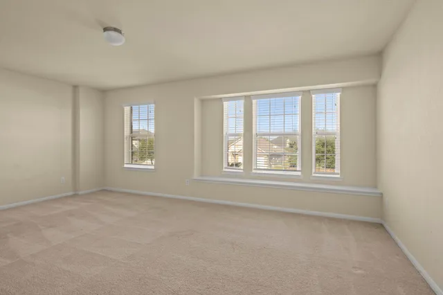 a view of an empty room and a window