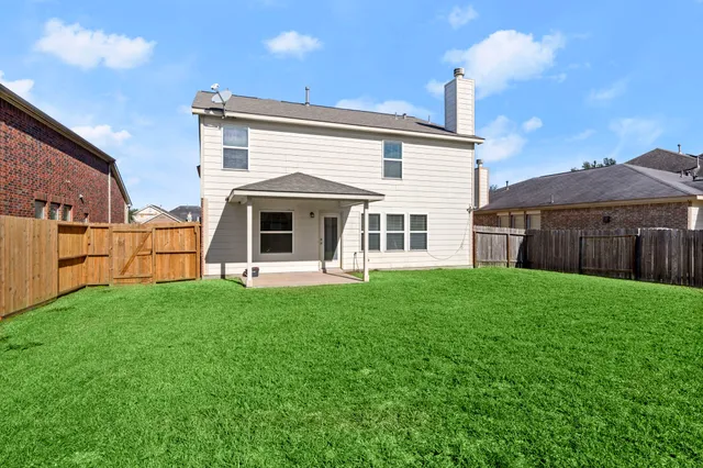 a view of a house with a backyard