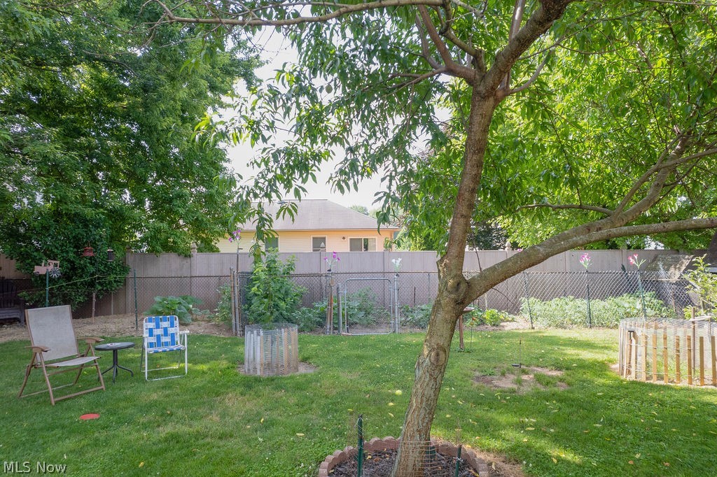 38667 Chestnut Ridge Road Elyria, OH 44035 - Photo 32 of 35 Expansive green lawn with mature trees and a chain-link fence