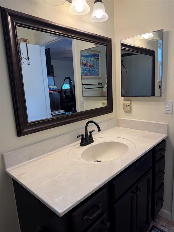 9529 Southwest 85th Avenue, Unit D Ocala, FL 34481 - Photo 14 of 21 a bathroom with a sink and a mirror