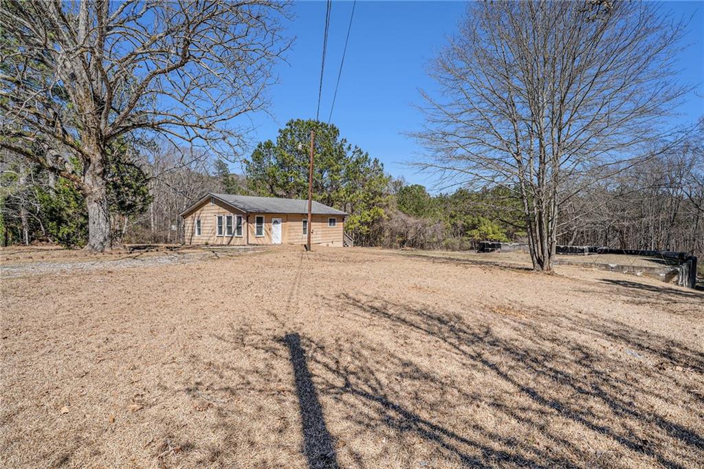 4065 Thaxton Road Atlanta, GA 30349 - Photo 1 of 1 a house with trees in front of it