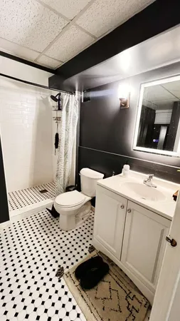a bathroom with a sink toilet and shower