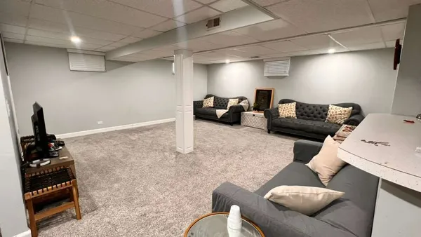 a living room with furniture and a mirror