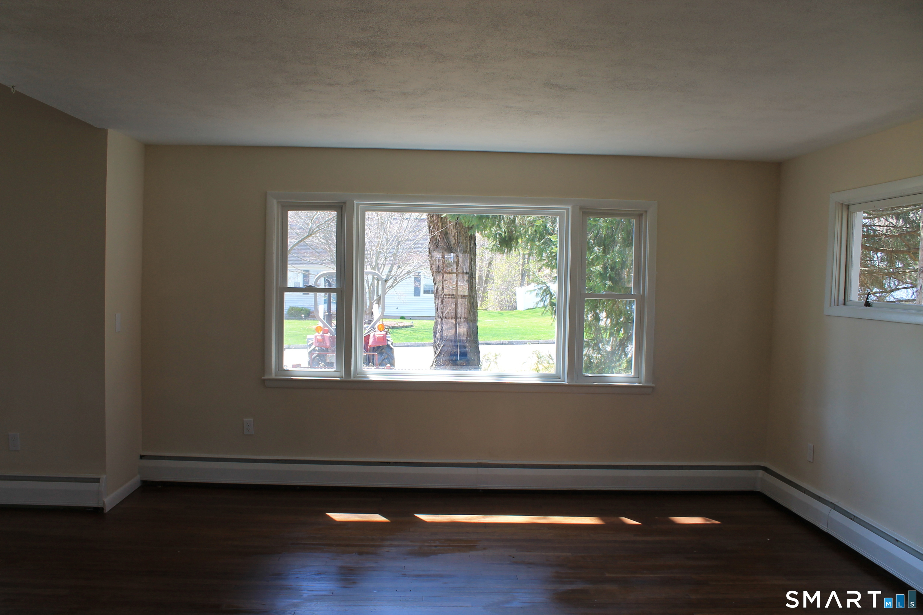 134 Sunset Street Windsor Locks, CT 06096 - Photo 13 of 23 an empty room with wooden floor and windows