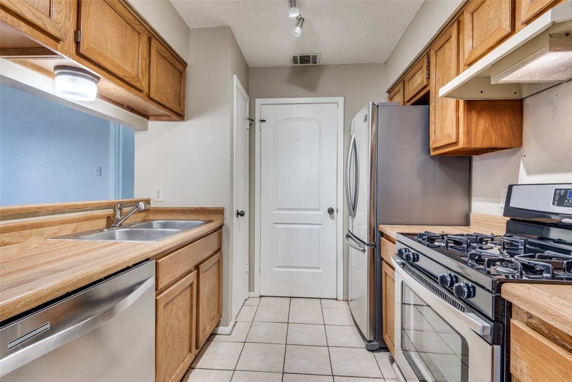 3603 Leafield Drive, Unit A Austin, TX 78749 - Photo 5 of 12 a kitchen with a stove and a sink