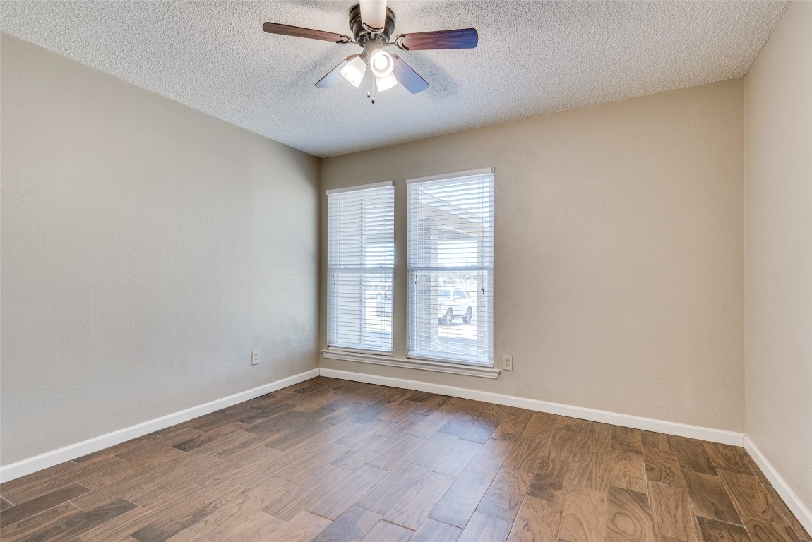 3603 Leafield Drive, Unit A Austin, TX 78749 - Photo 10 of 12 an empty room with chandelier fan and windows