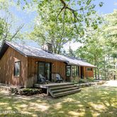 a view of a house with backyard porch and sitting area