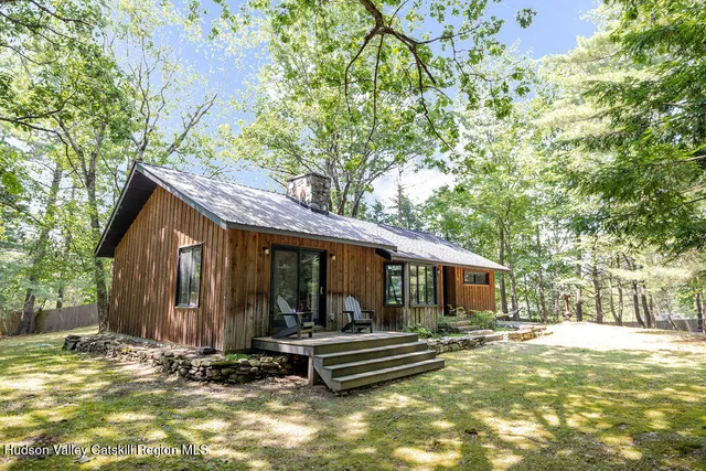 a view of a house with backyard porch and sitting area