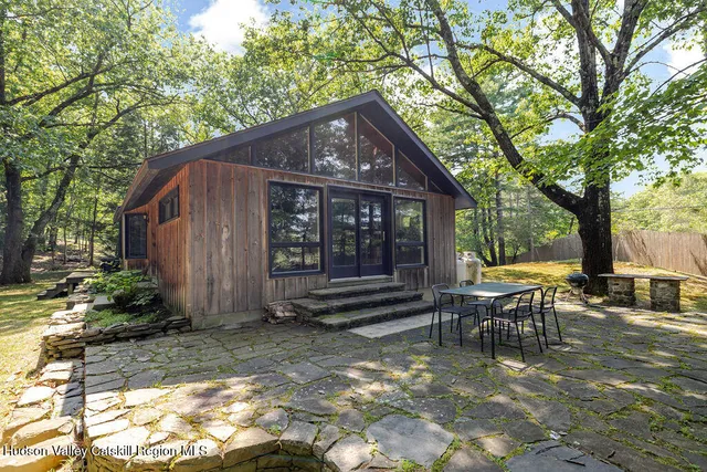 a view of a house with backyard and sitting area