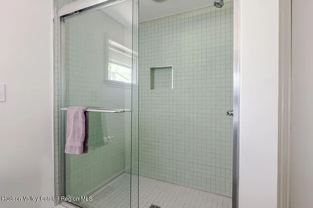 a bathroom with a glass shower door