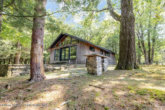 a view of a house with backyard and a tree
