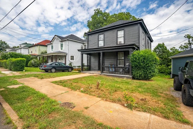 a front view of a house with swimming pool having outdoor seating