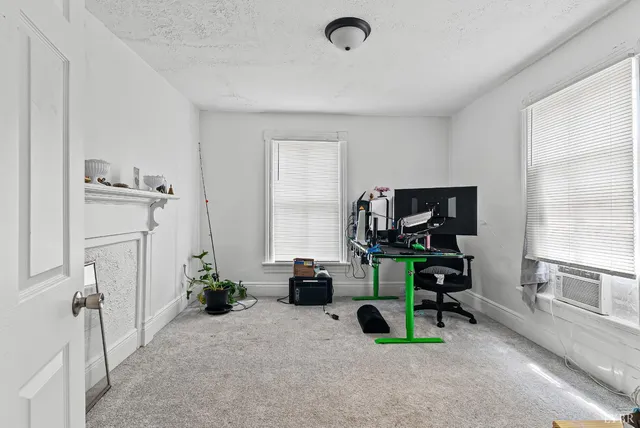 a view of a livingroom with furniture and a flat screen tv