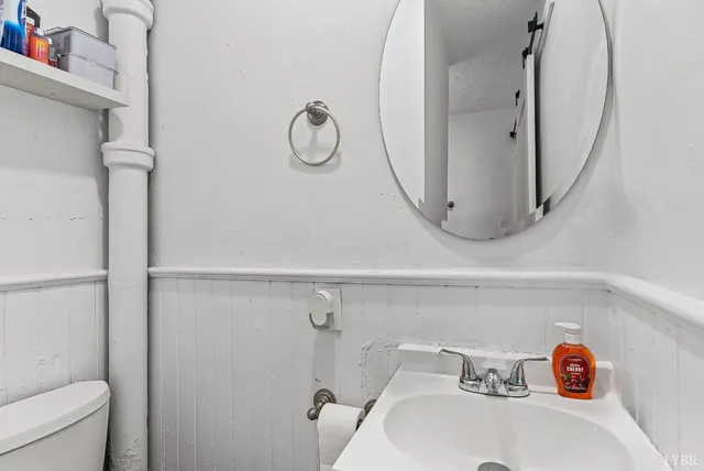 a bathroom with a sink a mirror and shower