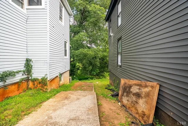 a view of a house with a backyard and balcony