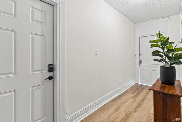 a view of a hallway with wooden floor