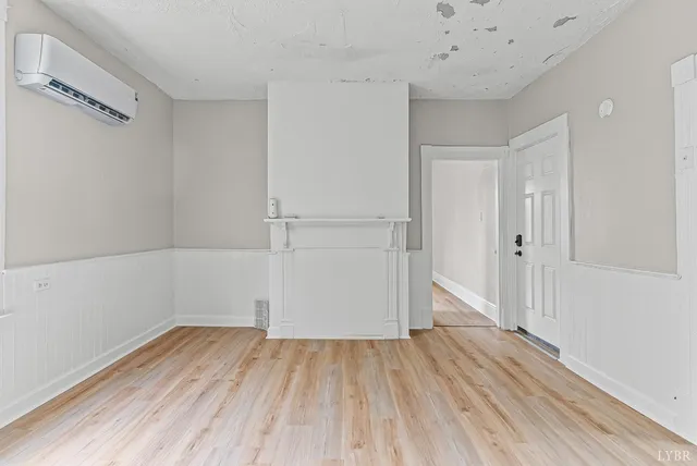 a view of a room with wooden floor