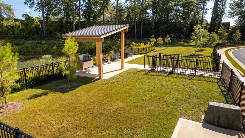 3373 Fence Road Northeast, Unit D4 Dacula, GA 30019 - Photo 19 of 40 a view of a swimming pool with a patio and a yard