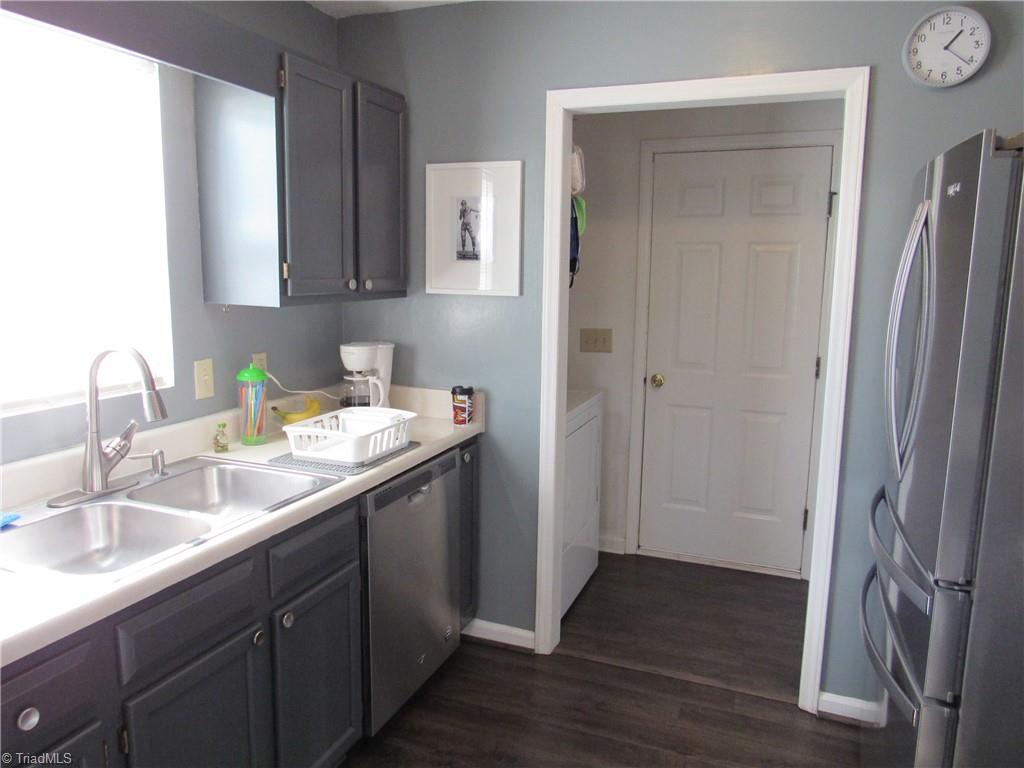 1819 Ebert Road Winston-Salem, NC 27103 - Photo 16 of 29 Kitchen with Laminate flooring, stainless appliances. Straight ahead is the laundry area and the door to the garage.
