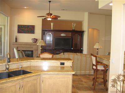 245 Loch Lomond Road Rancho Mirage, CA 92270 - Photo 13 of 21 a kitchen with a sink and a fireplace with wooden floor
