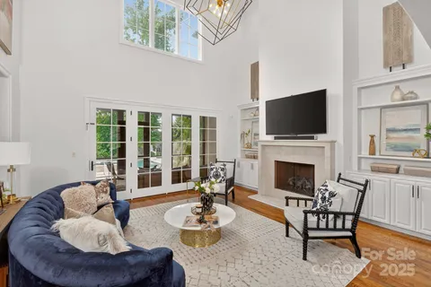 a living room with furniture a fireplace and a flat screen tv