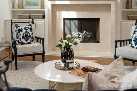 a living room with furniture and a painting on the wall