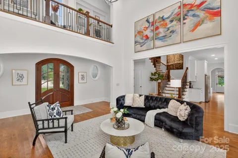 a large white kitchen with lots of counter space and furniture