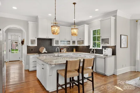 a kitchen with center island and windows